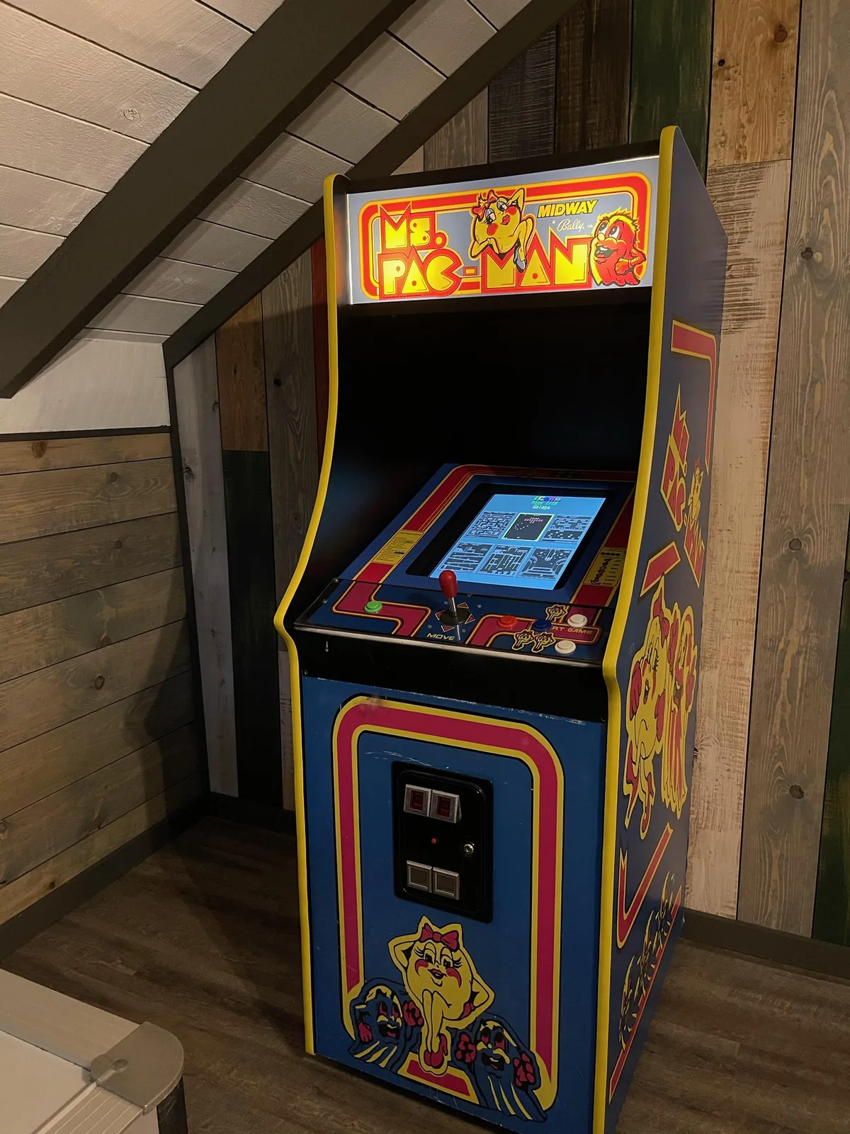 A dedicated view of the classic arcade machine with colorful retro-style graphics, setting the tone for nostalgic gaming fun. The mood is playful, inviting friendly competition and laughter.
